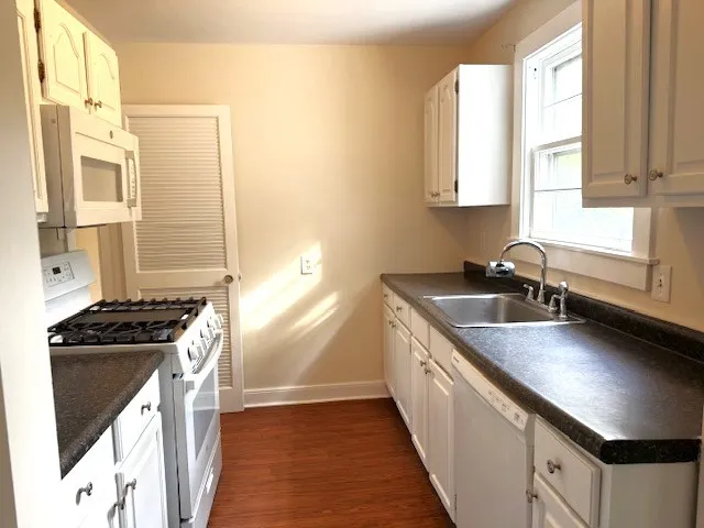 a stove top oven sitting inside of a kitchen