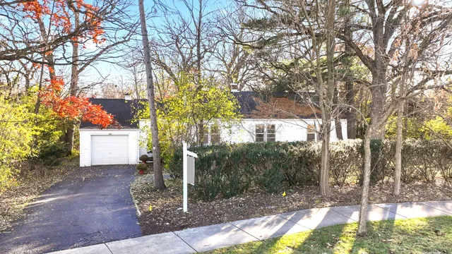 a view of a house with a yard covered in snow