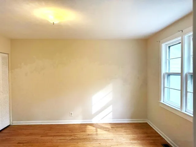 a view of a room with wooden floor and a sink