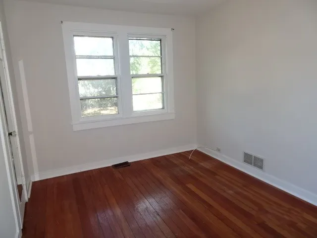 an empty room with wooden floor