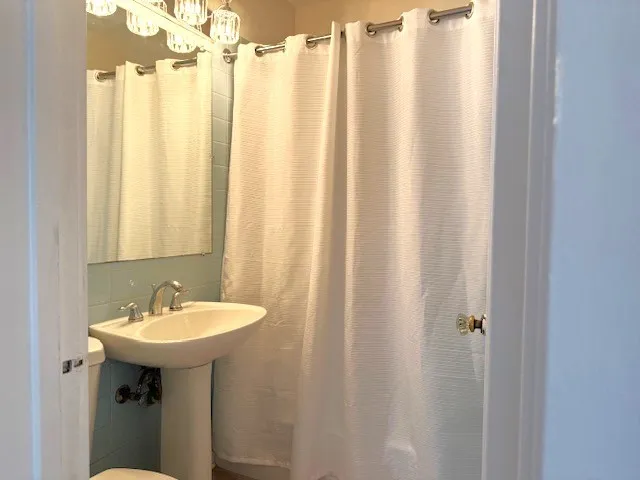 a view of a room with wooden floor and a window