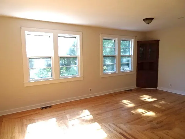 a kitchen with granite countertop white cabinets and a stove a sink