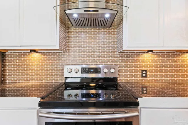 a kitchen with cabinets stainless steel appliances and a counter space