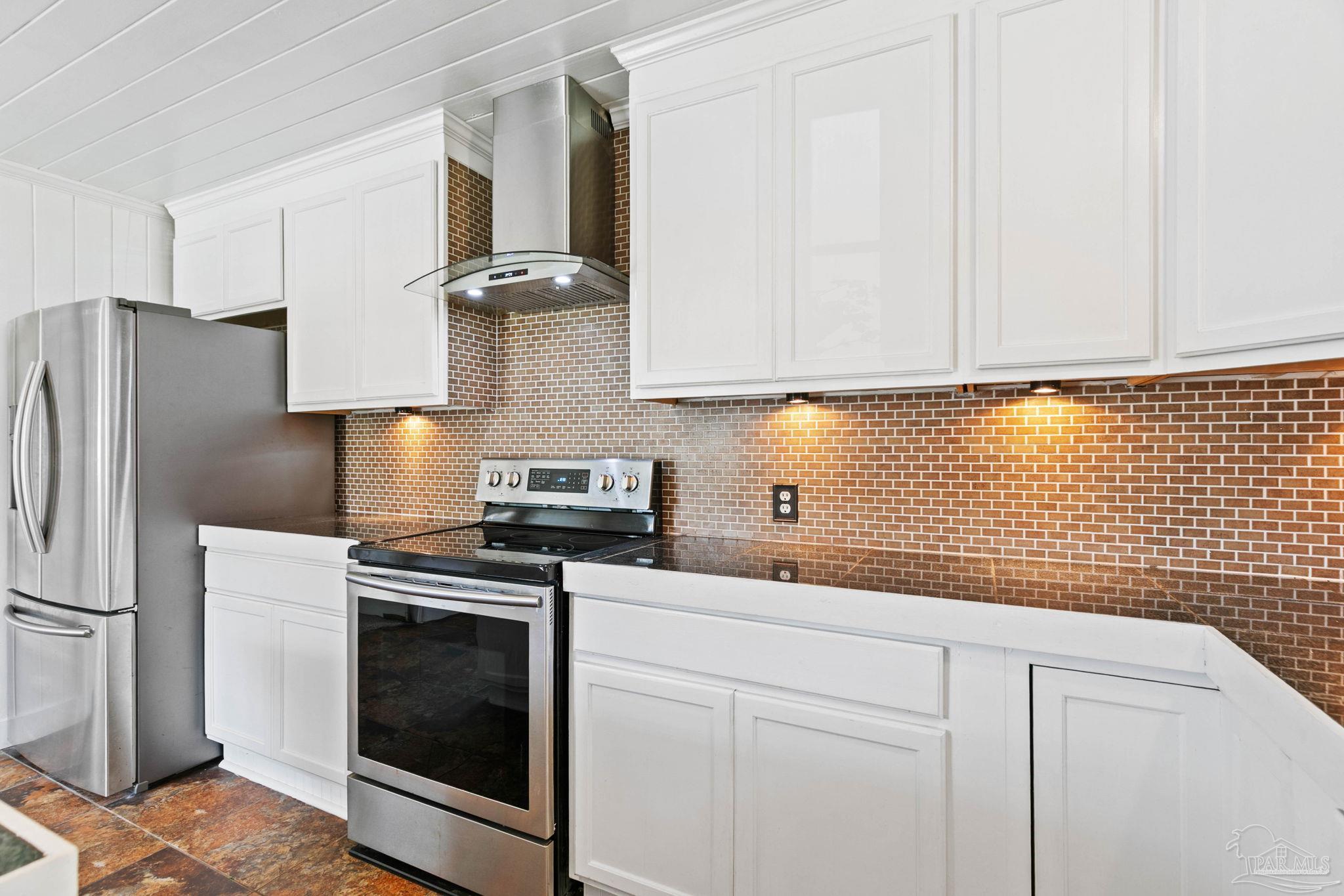 301 East Craig Street Atmore, AL 36502 - Photo 15 of 64 a kitchen with cabinets stainless steel appliances and a counter space