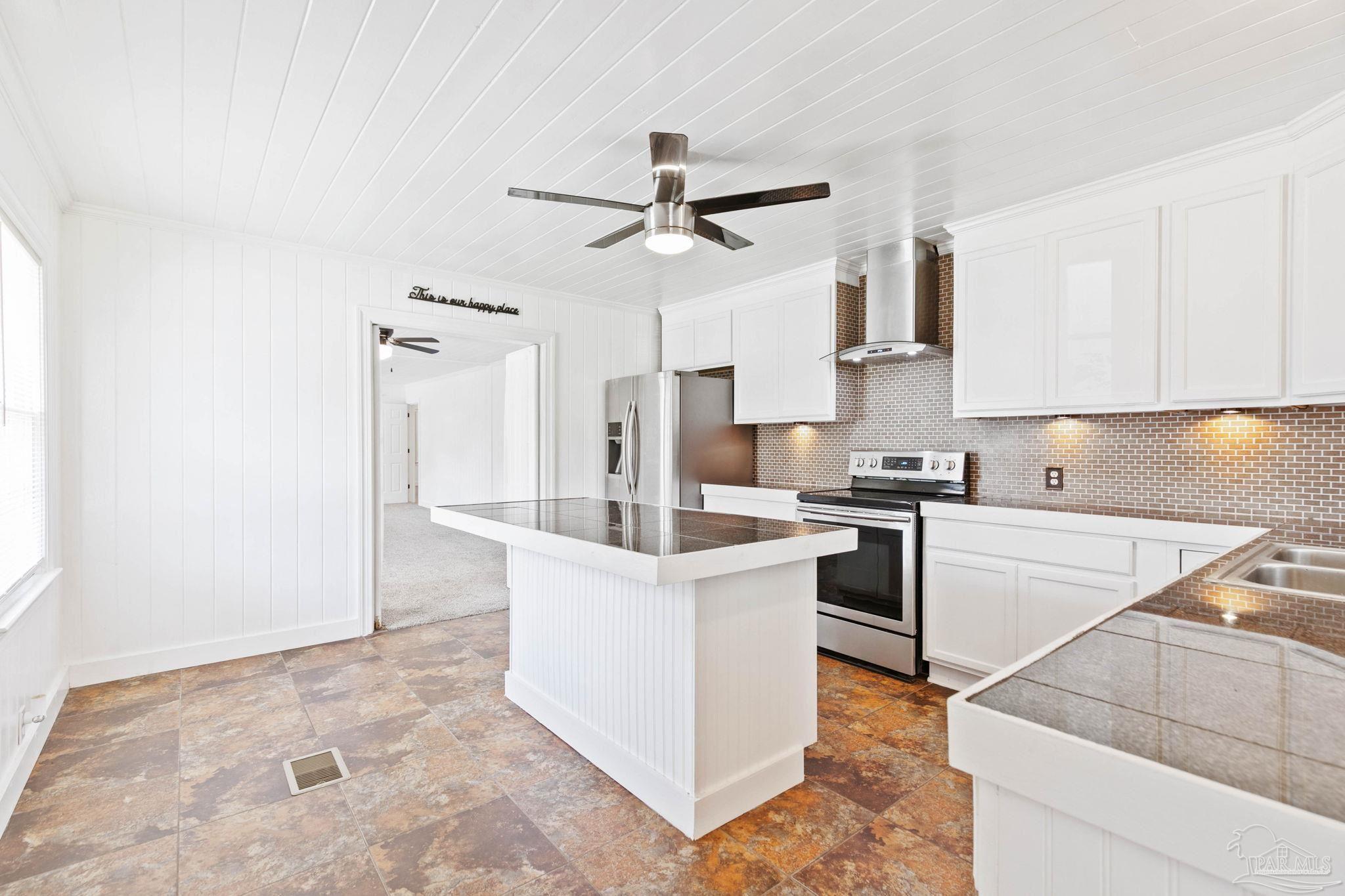 301 East Craig Street Atmore, AL 36502 - Photo 17 of 64 a kitchen with white cabinets and white appliances