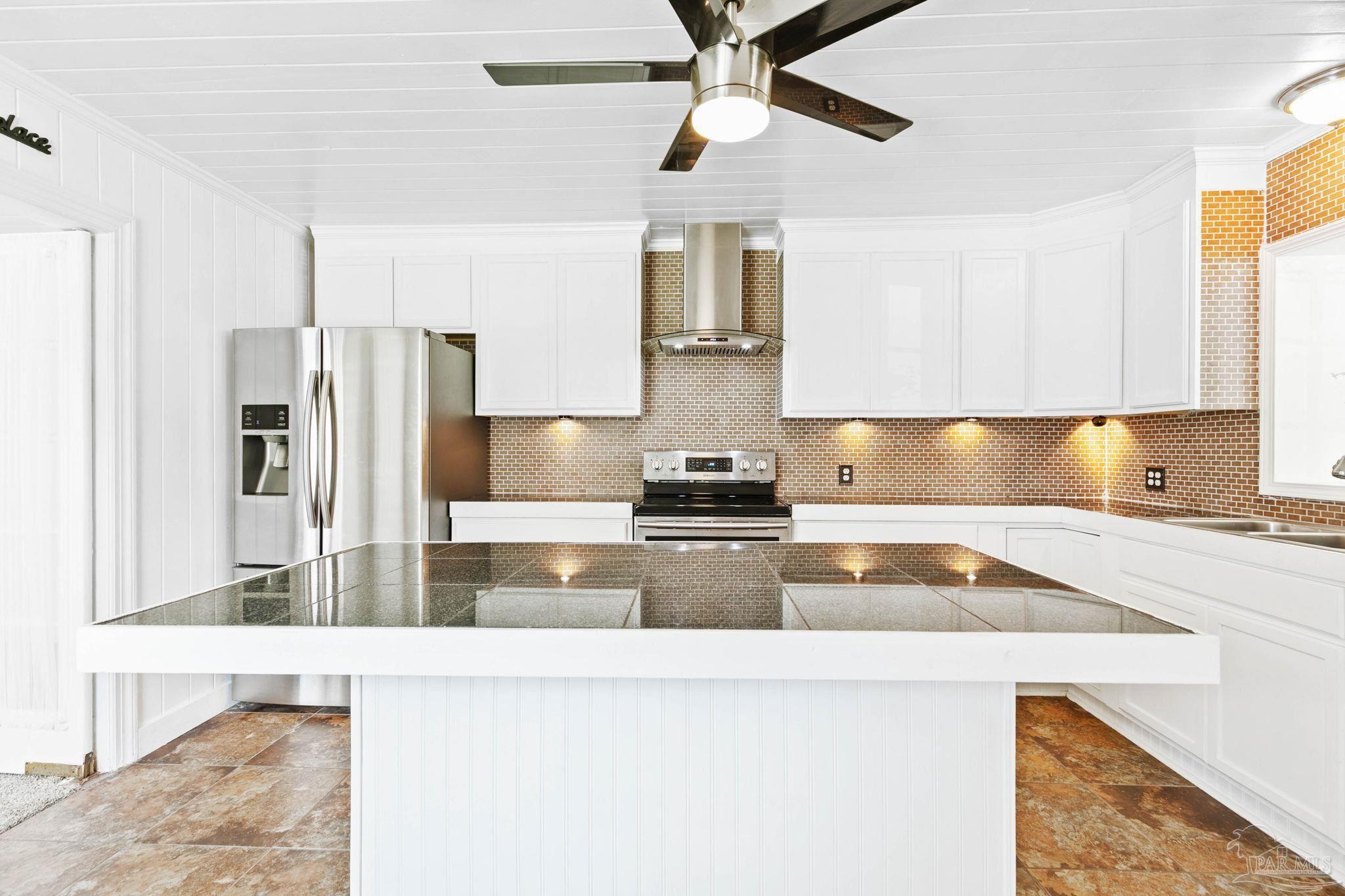 301 East Craig Street Atmore, AL 36502 - Photo 2 of 64 a kitchen with stainless steel appliances granite countertop a sink a stove and a refrigerator