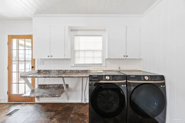 an empty room with wooden floor ceiling fan and windows