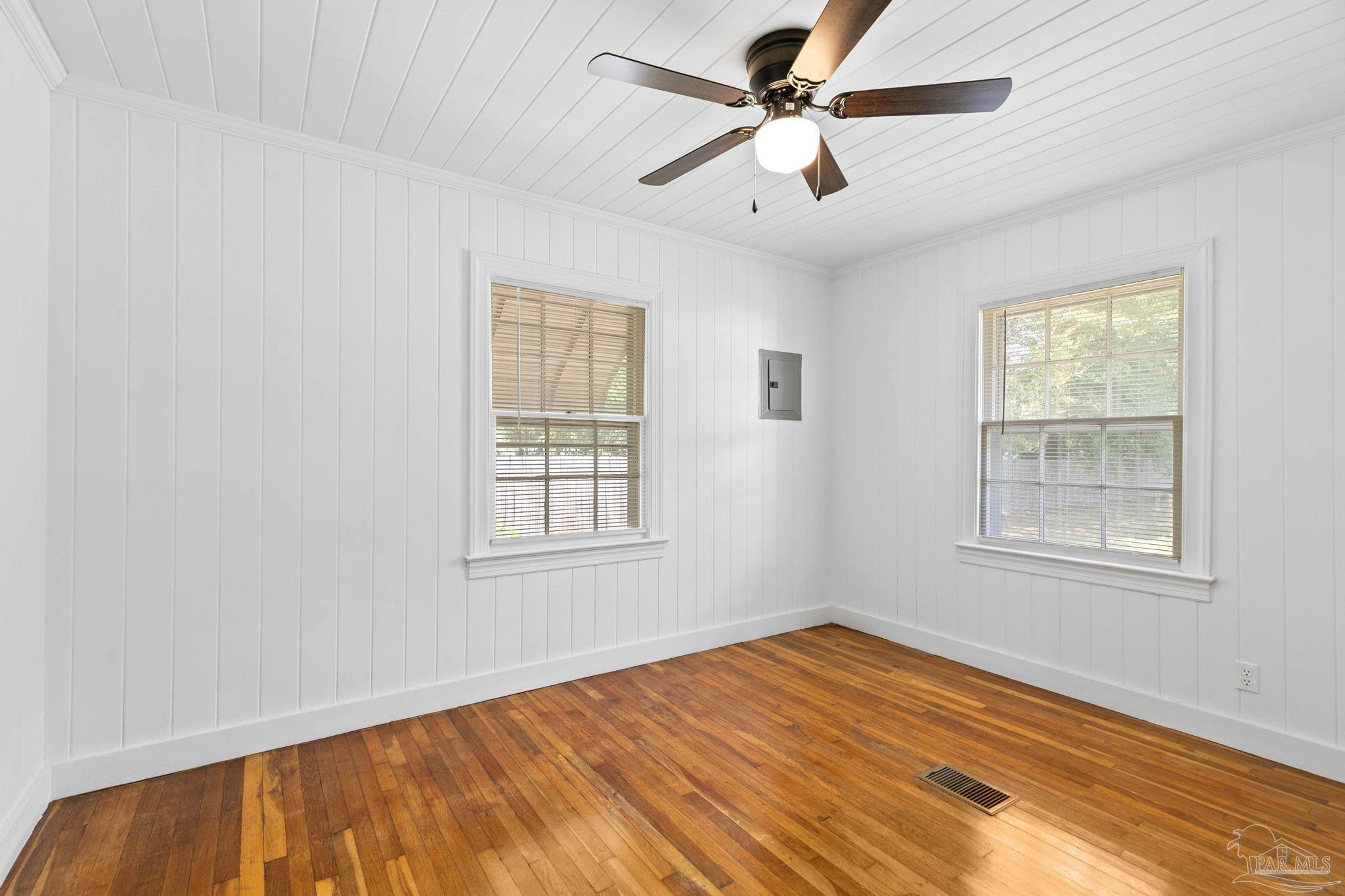 301 East Craig Street Atmore, AL 36502 - Photo 25 of 64 an empty room with wooden floor ceiling fan and windows