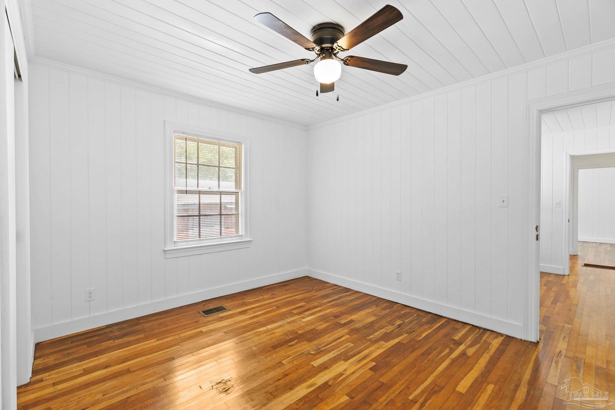 301 East Craig Street Atmore, AL 36502 - Photo 29 of 64 wooden floor in an empty room with a window