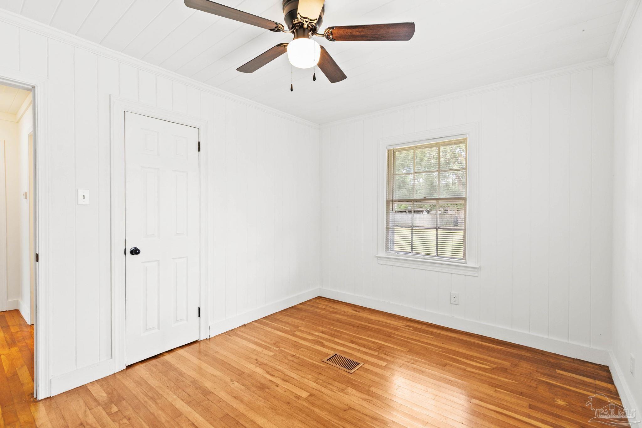 301 East Craig Street Atmore, AL 36502 - Photo 36 of 64 a view of an empty room with window and wooden floor