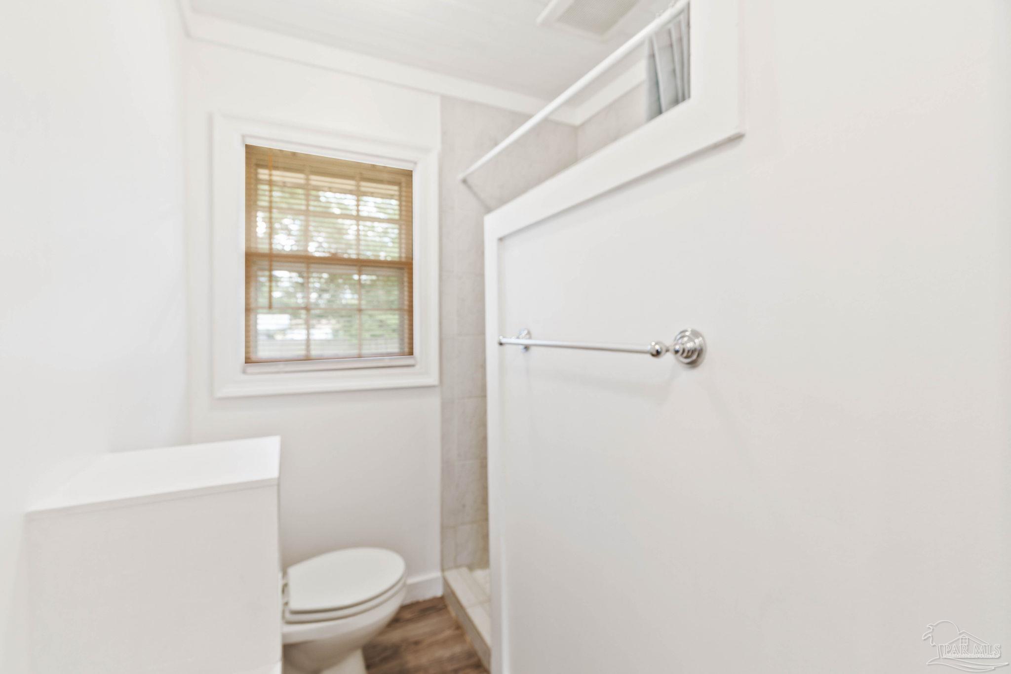 301 East Craig Street Atmore, AL 36502 - Photo 37 of 64 a white toilet sitting next to a bathroom sink and vanity