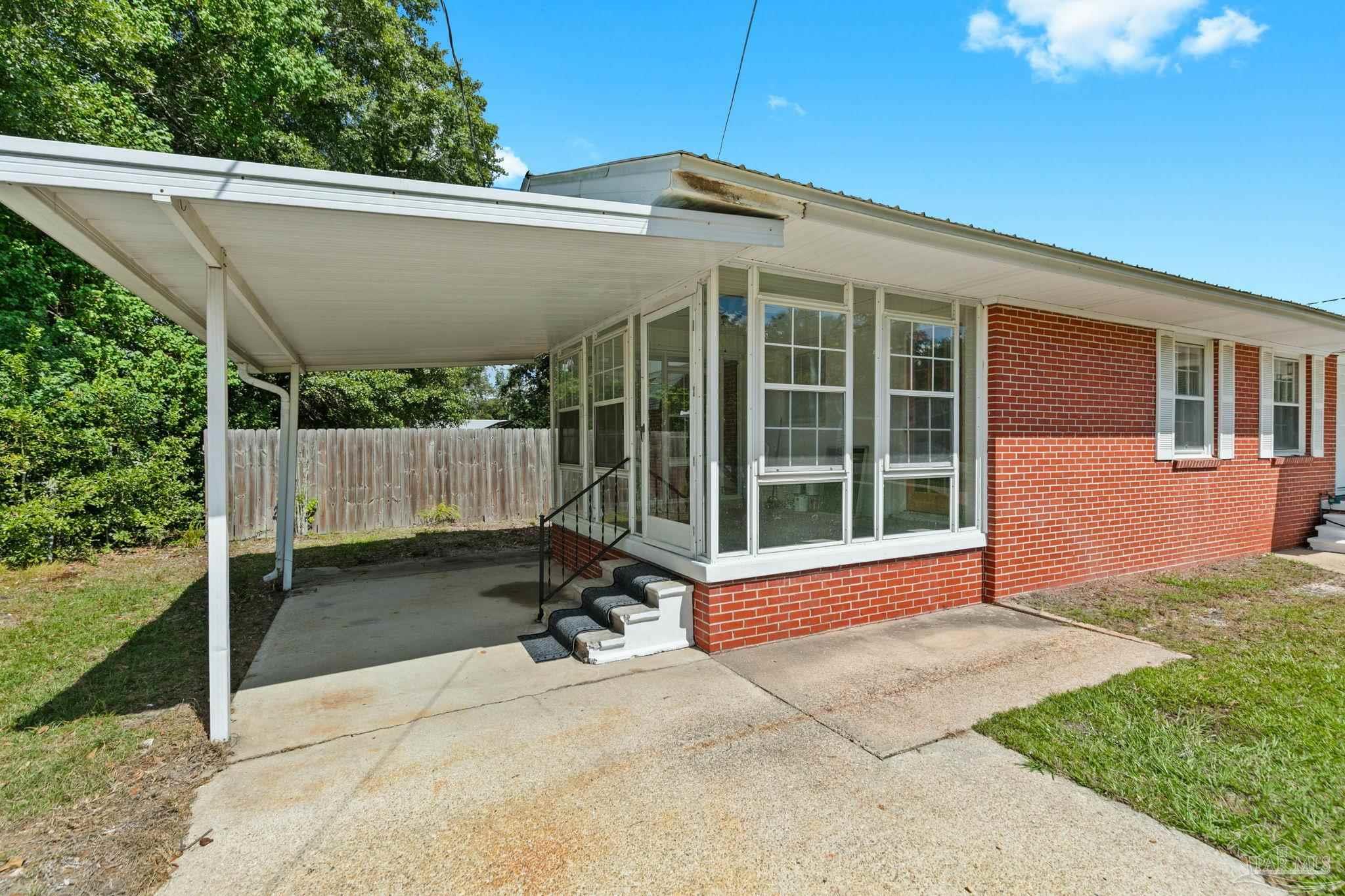 301 East Craig Street Atmore, AL 36502 - Photo 38 of 64 a backyard of a house with yard and outdoor seating