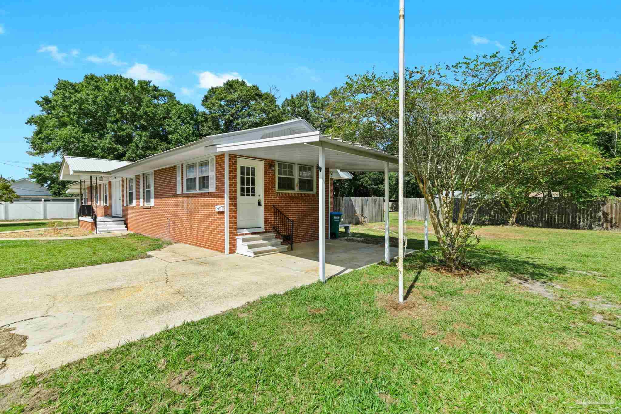 301 East Craig Street Atmore, AL 36502 - Photo 41 of 64 a view of a house with a backyard and a tree