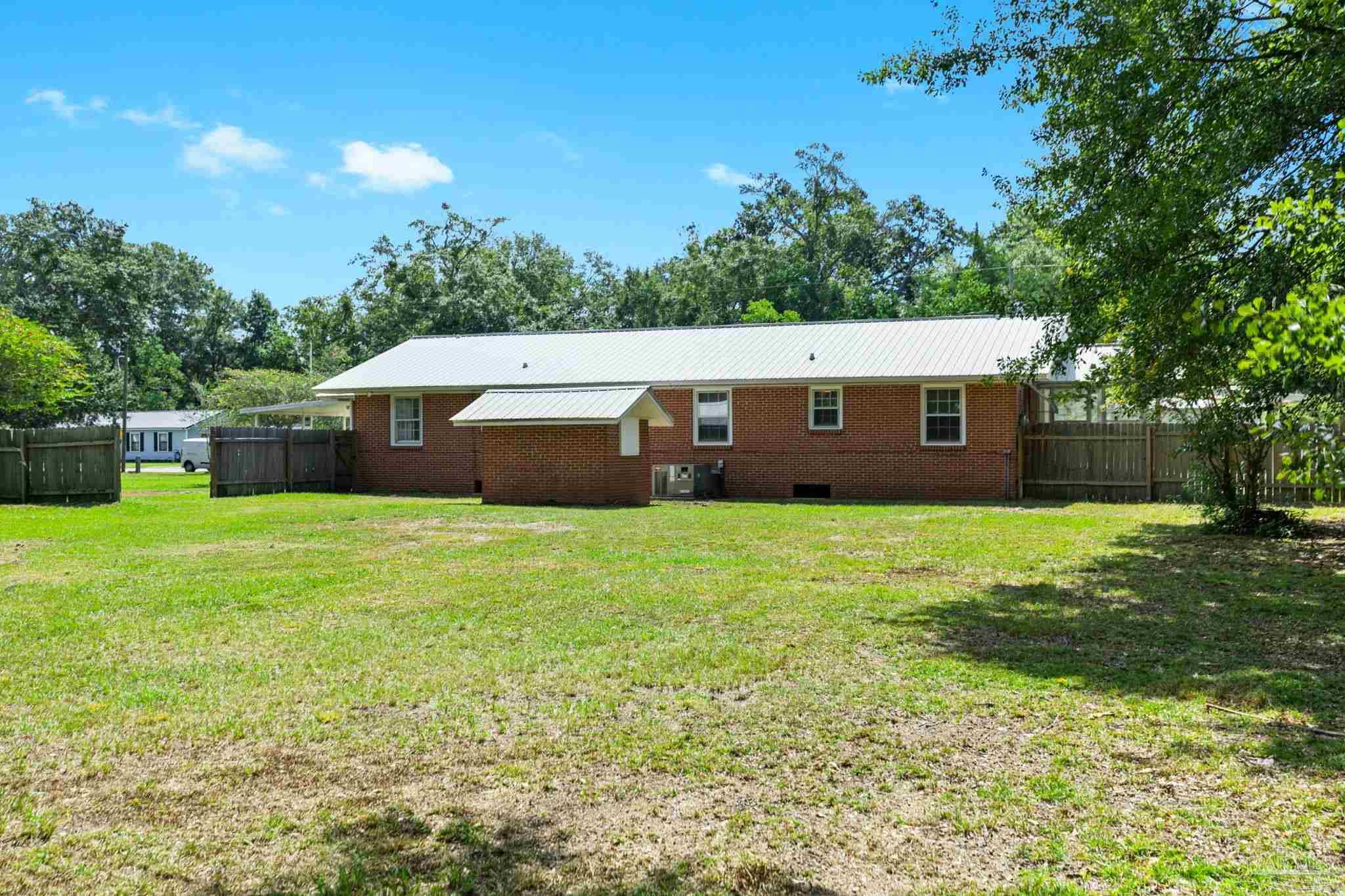 301 East Craig Street Atmore, AL 36502 - Photo 47 of 64 a view of a house with a backyard