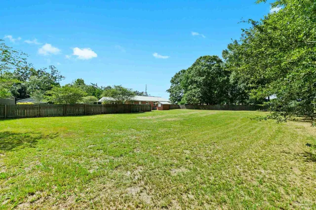 an aerial view of a house with swimming pool garden and outdoor seating