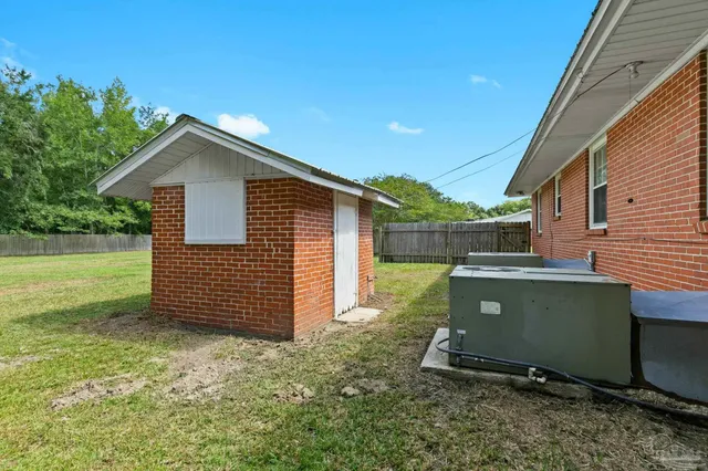 a view of a house with a backyard and a garden