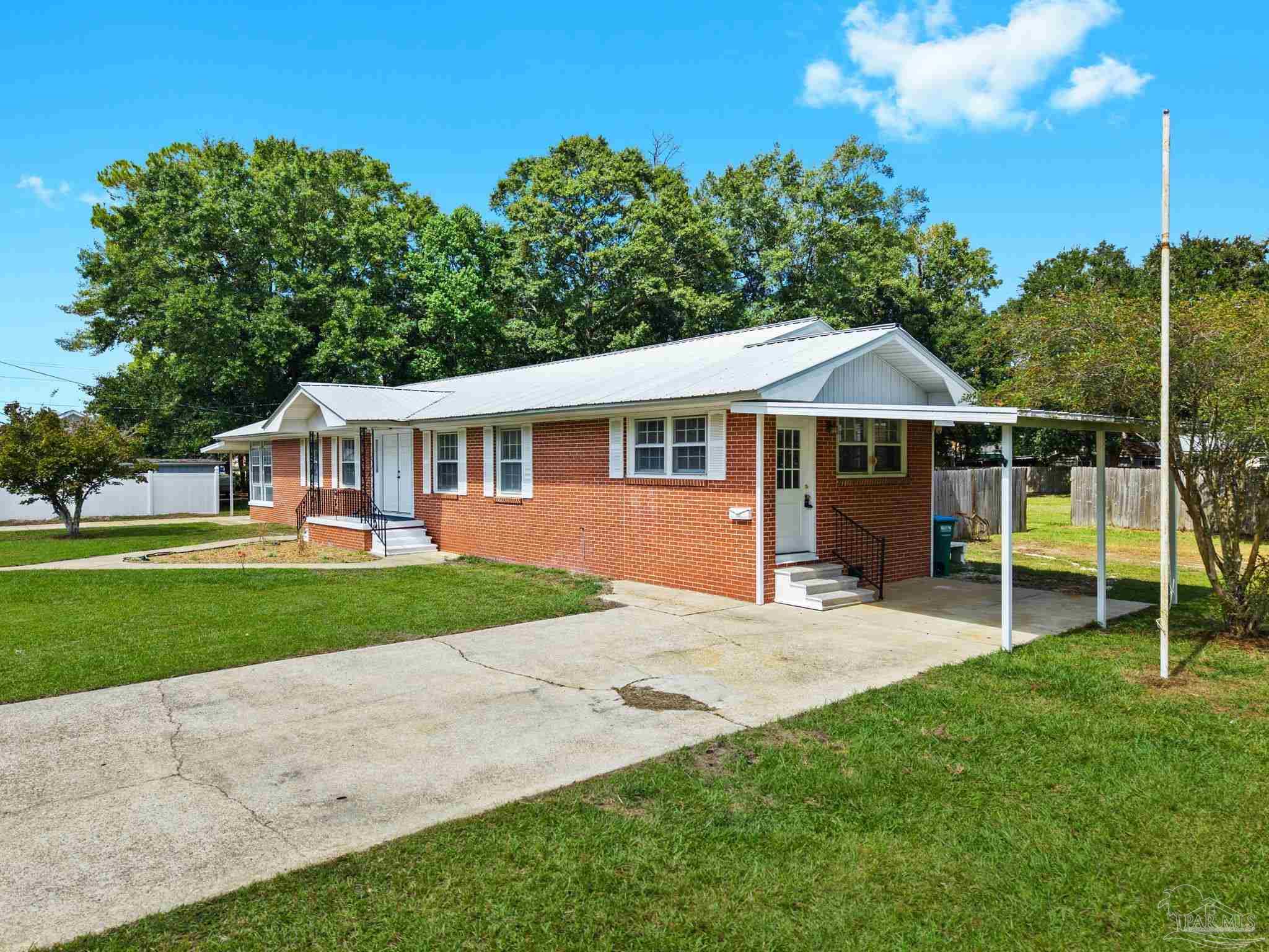 301 East Craig Street Atmore, AL 36502 - Photo 54 of 64 a view of a house with a yard and sitting area