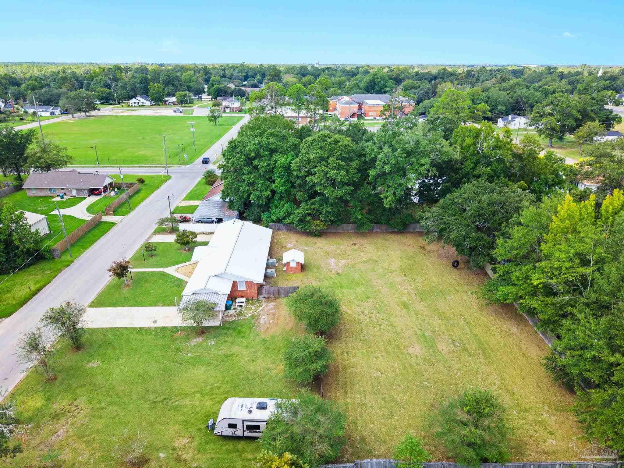 301 East Craig Street Atmore, AL 36502 - Photo 57 of 64 a view of a garden with a building in the background