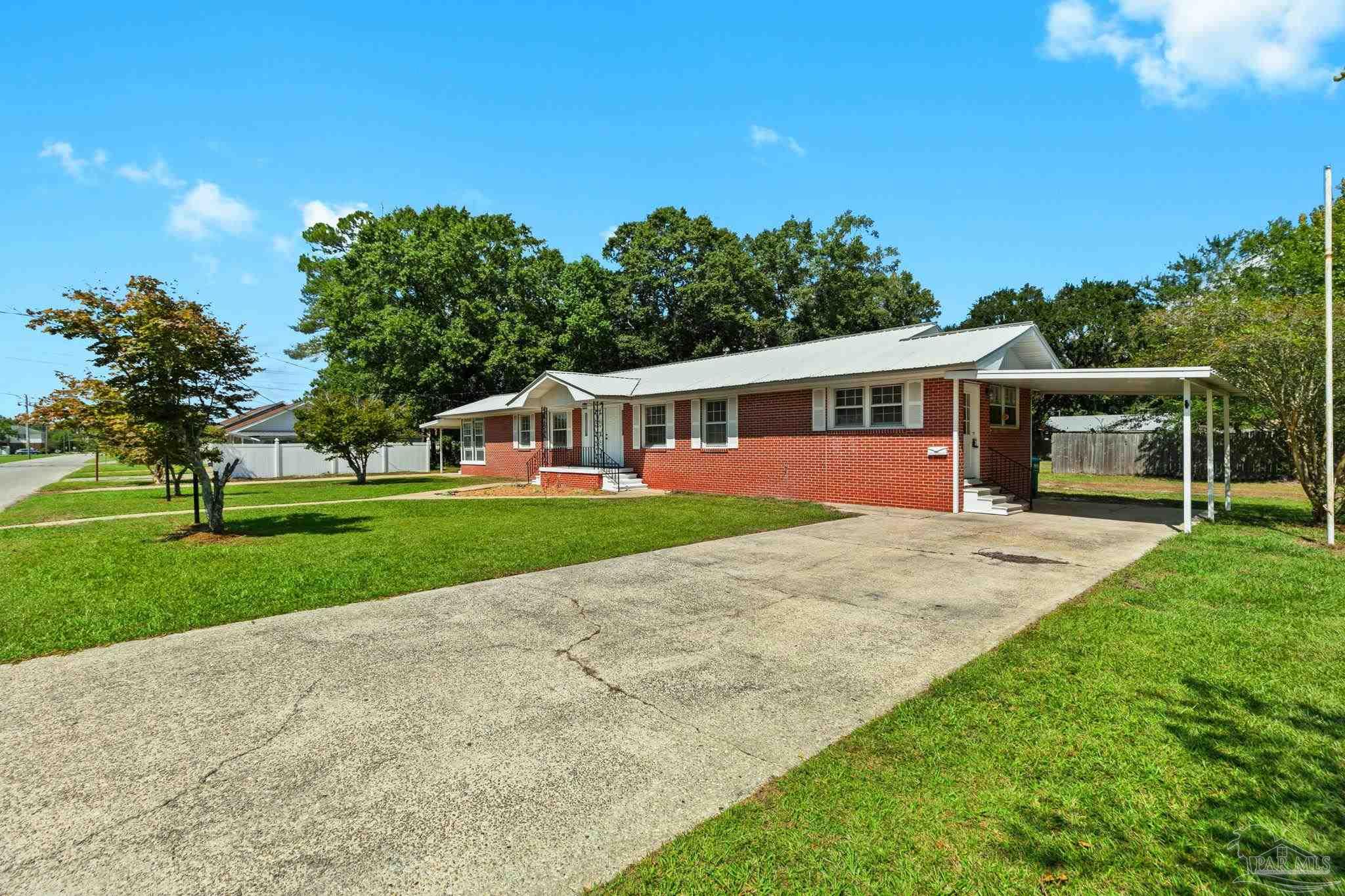 301 East Craig Street Atmore, AL 36502 - Photo 63 of 64 a view of a house with a backyard and a garden