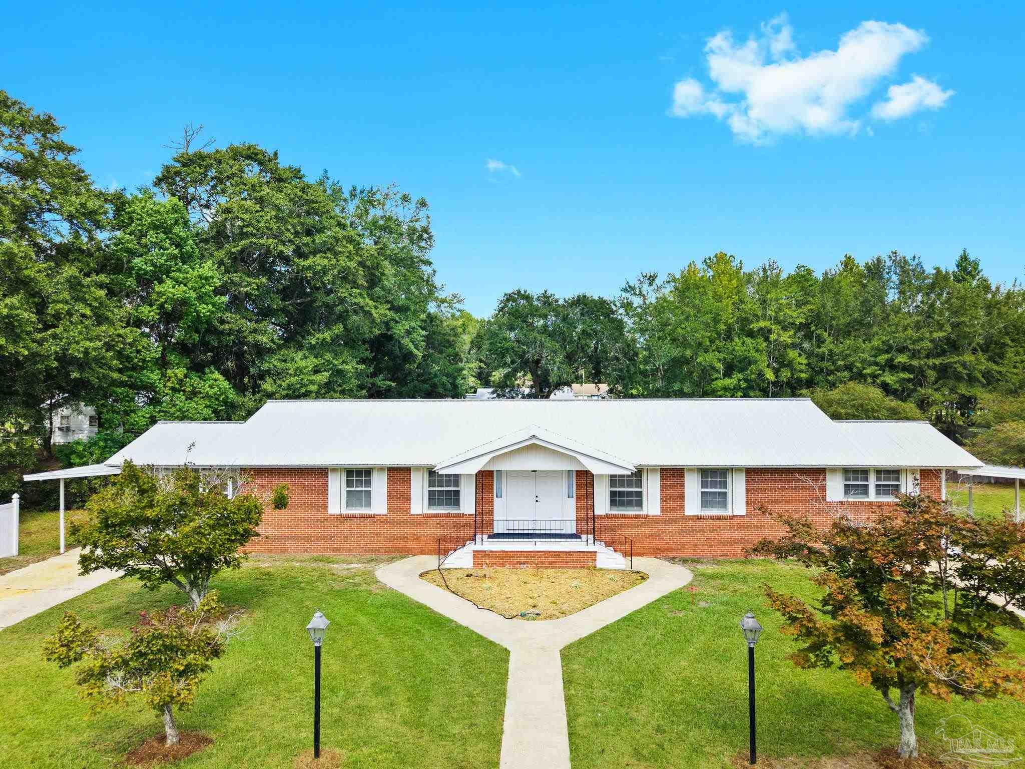 301 East Craig Street Atmore, AL 36502 - Photo 64 of 64 a front view of a house with yard porch and green space