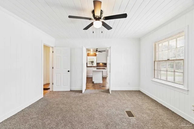 a kitchen with a sink stainless steel appliances and window