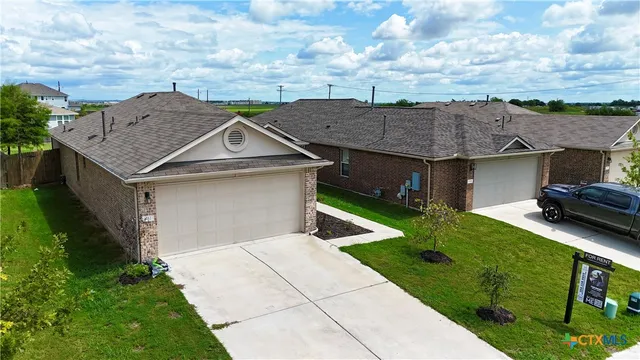 a aerial view of a house with a yard table and chairs