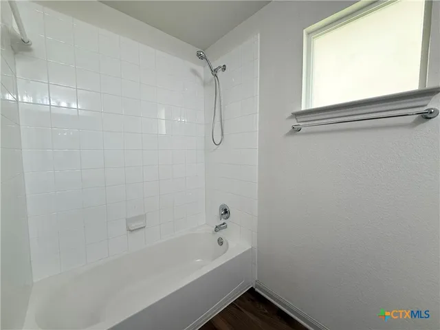 a bathroom with a bathtub and a shower