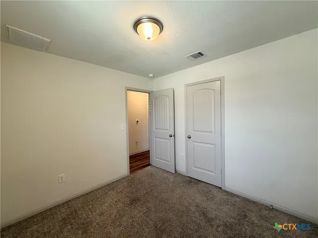 an empty room with closet area