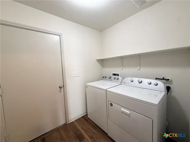 a view of storage and utility room with washer and dryer