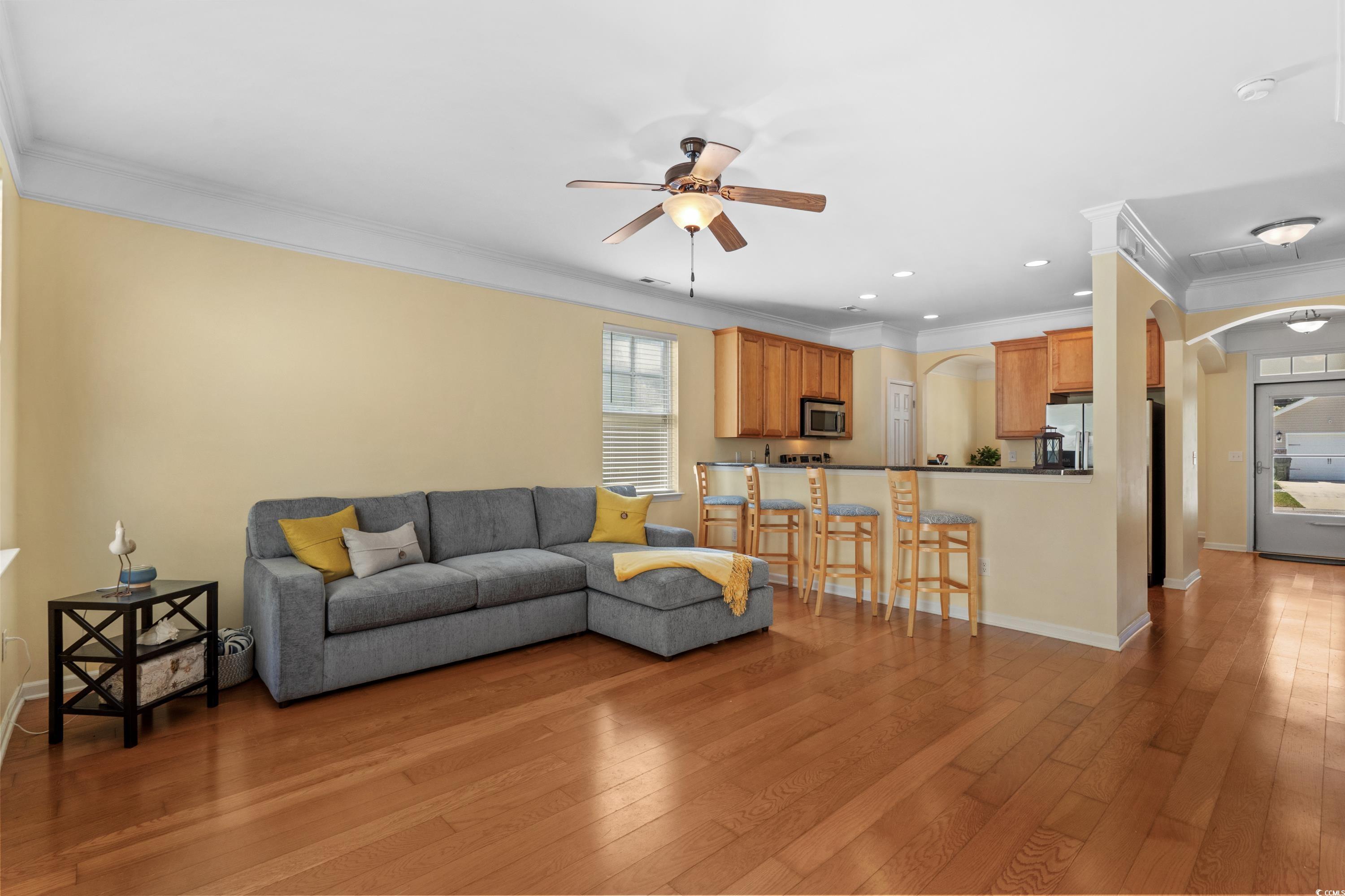 908 Oglethorpe Drive Conway, SC 29527 - Photo 11 of 40 Living room featuring crown molding, arched walkwa
