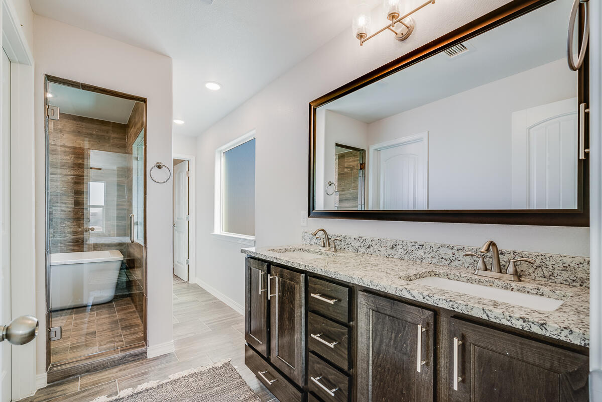 15352 Resolve Avenue El Paso, TX 79938 - Photo 17 of 22 a bathroom with a granite countertop sink and a mirror