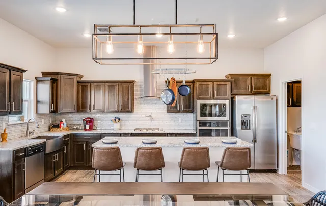 a large kitchen with a table and chairs
