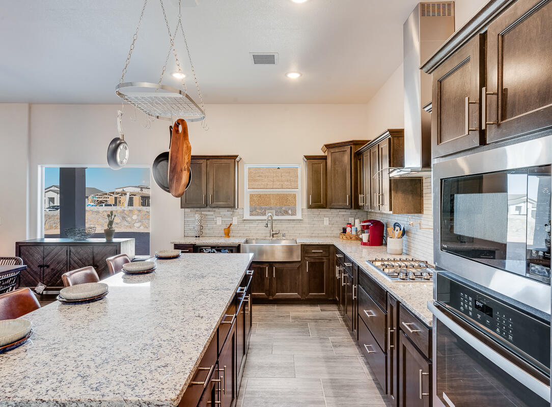 15352 Resolve Avenue El Paso, TX 79938 - Photo 6 of 22 a large kitchen with stainless steel appliances granite countertop a stove and a sink