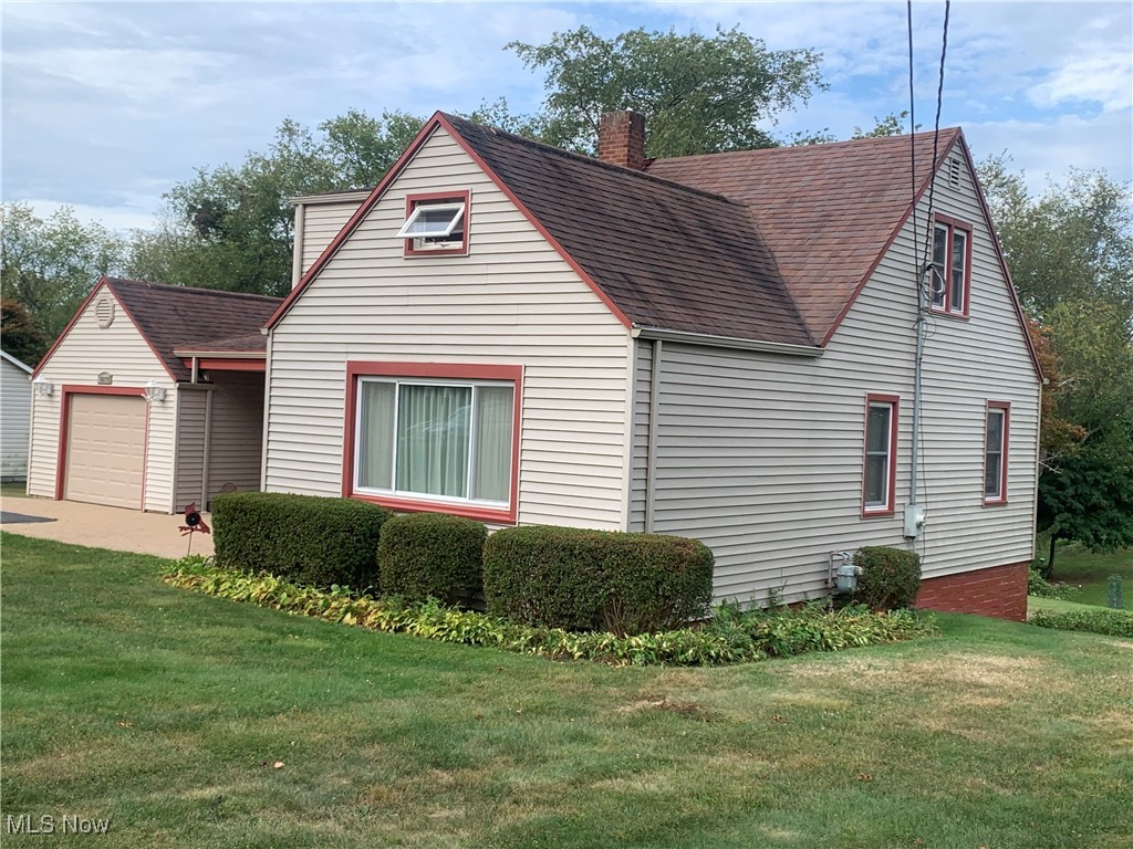 16879 Ridgeview Drive East Liverpool, OH 43920 - Photo 2 of 22 View of front facade with a garage, an outdoor structure, and a front lawn