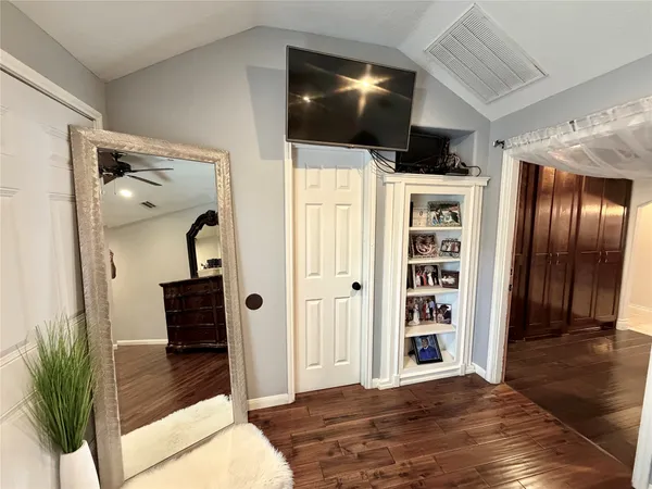 a bedroom with a bed and wooden floor