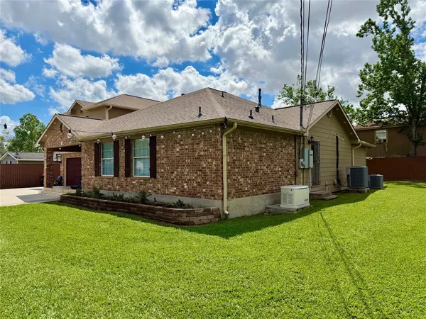 a view of a house with a yard and sitting area