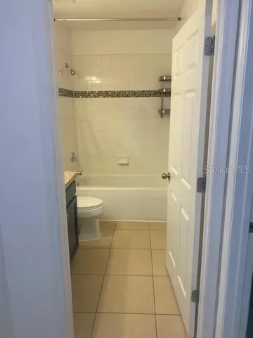 a bathroom with a granite countertop shower a toilet and a shower