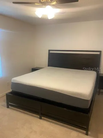 a bed sitting in a bedroom next to a window