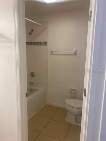 a bathroom with a granite countertop toilet a sink and shower