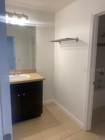 a bathroom with a sink vanity and a mirror