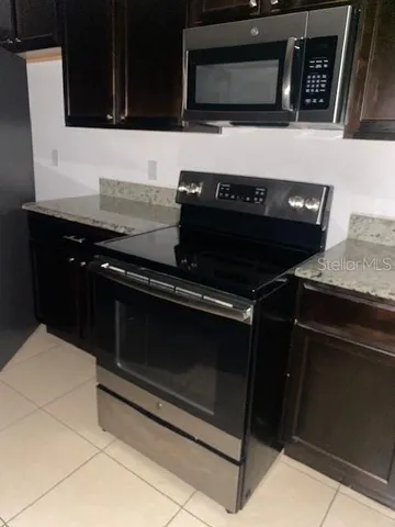 a kitchen with stainless steel appliances a stove and a microwave