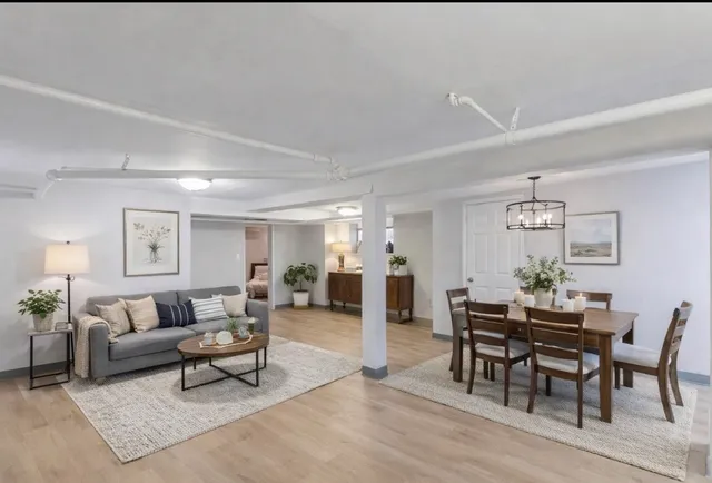 a living room with furniture and view of kitchen