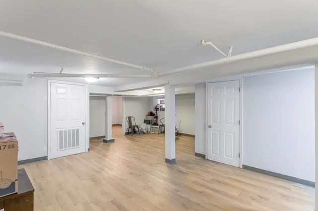 an empty room with closet and mirror