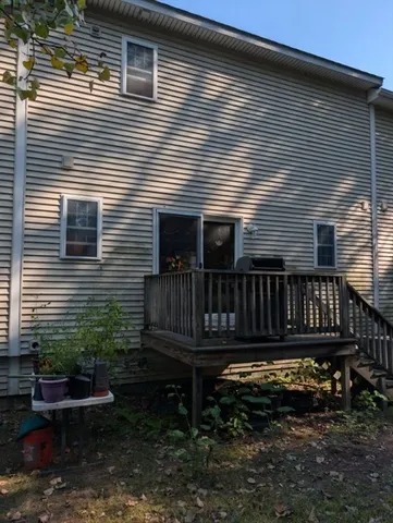 a view of a house with wooden deck