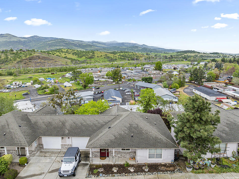 an aerial view of residential houses with outdoor space and street view