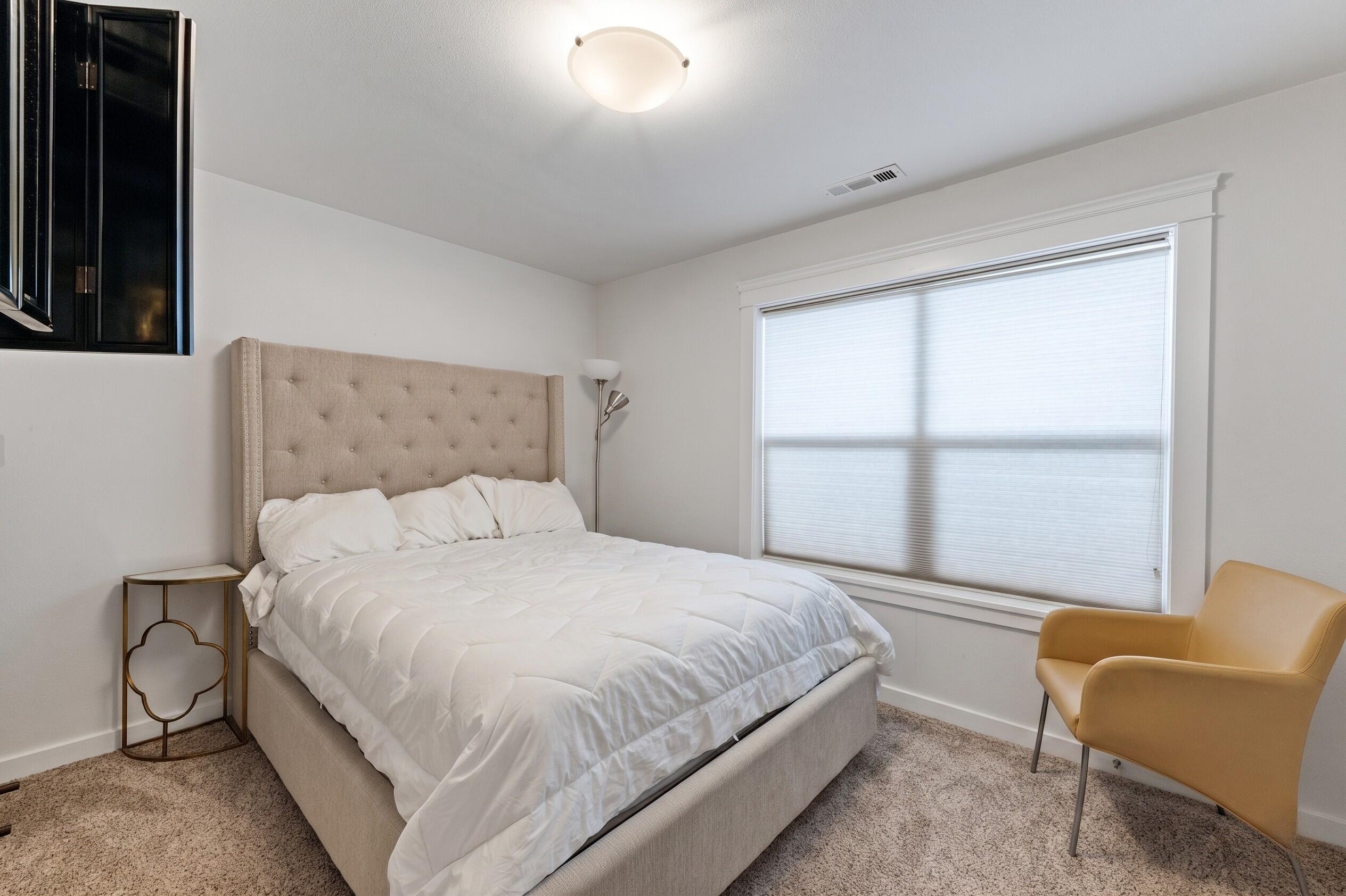 457 Elm Street Phoenix, OR 97535 - Photo 11 of 27 a bedroom with a bed chair and window