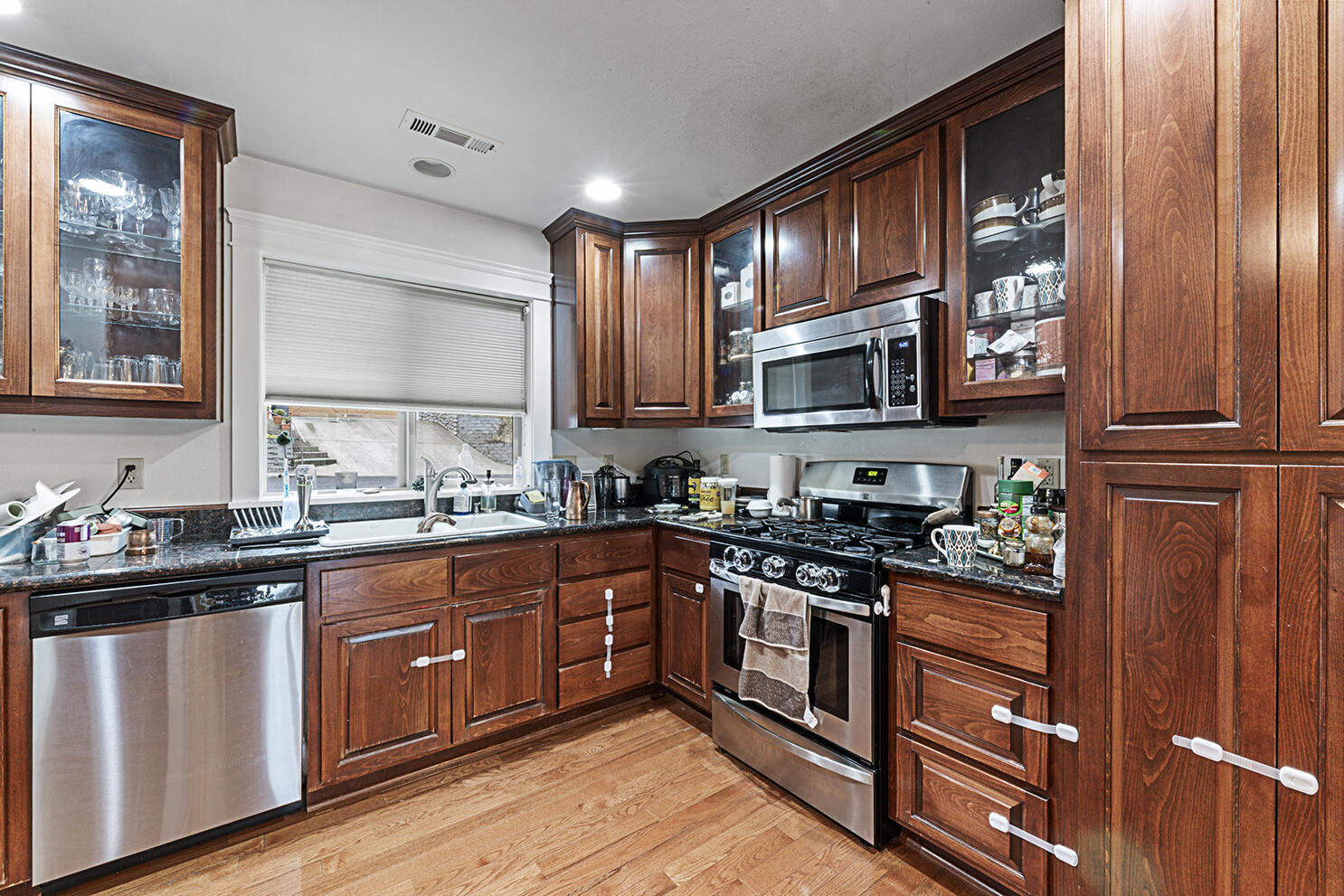 457 Elm Street Phoenix, OR 97535 - Photo 7 of 27 a kitchen with stainless steel appliances granite countertop a stove sink microwave and cabinets