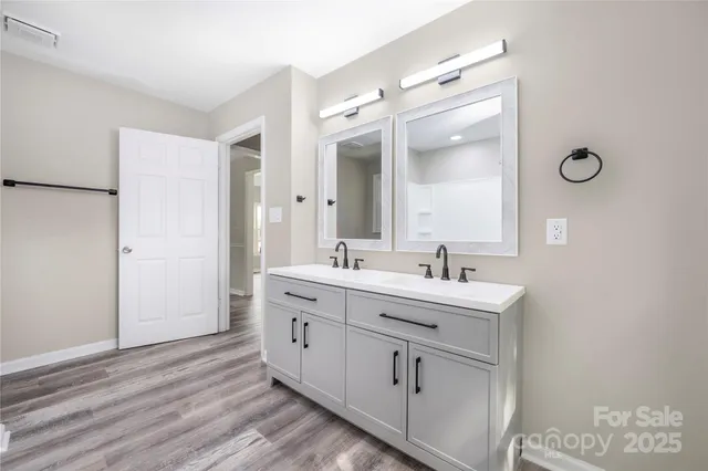 a bathroom with a double vanity sink mirror and