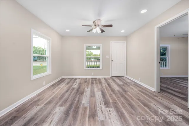 wooden floor in an empty room with a window