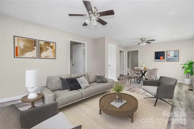 a living room with furniture a rug and a chandelier